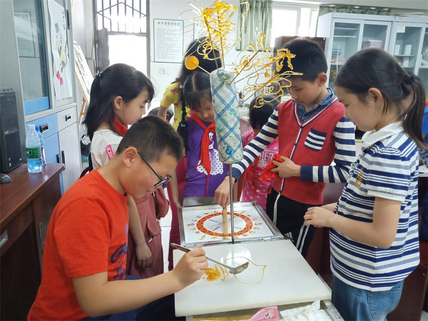 成都市回民小學學生學習糖畫，感受民俗文化。成都市民宗局供圖