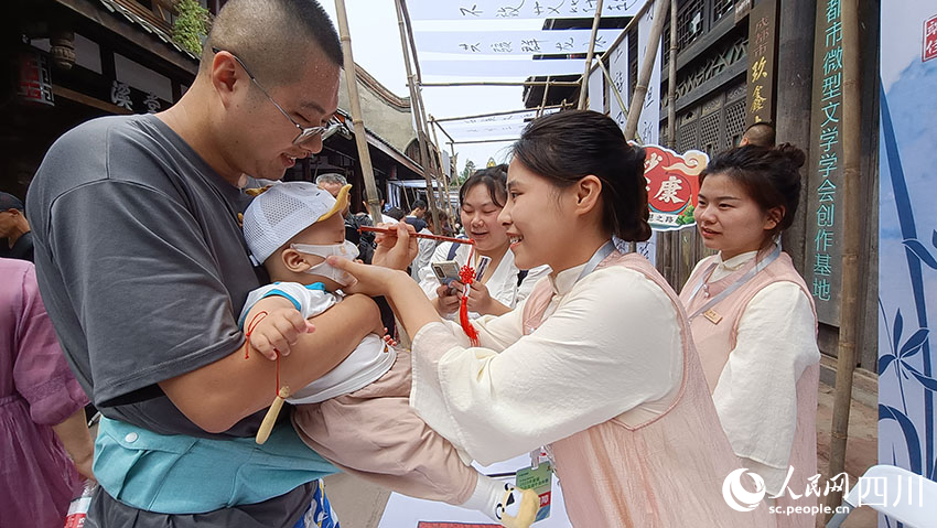 黃龍雅集上，工作人員為游客點朱砂，祈安康。吳舒婷攝