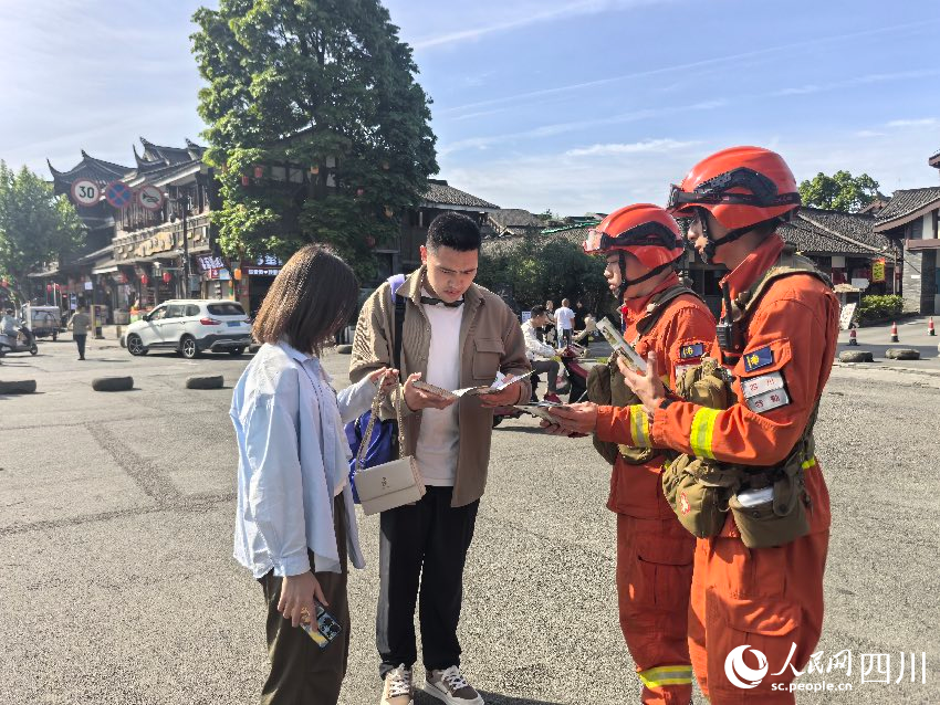 5月1日，都江堰景區，消防員唐平、譚弋飛正在進行防火宣傳。程雪力攝