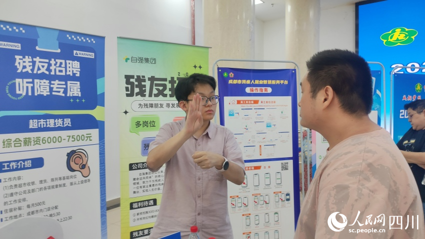 自強集團招聘專員用手語與應聘殘友溝通。施瑩攝